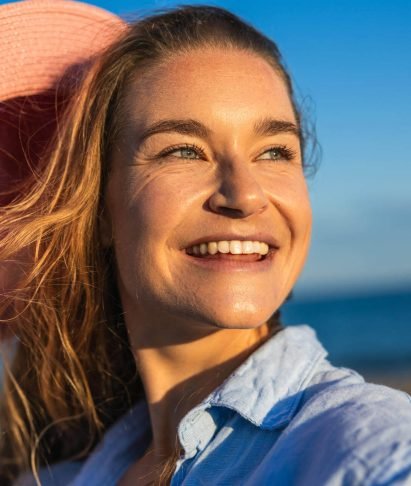caucasian-woman-holding-pink-hat-and-smiling-at-be-2025-01-10-05-17-58-utc.jpg